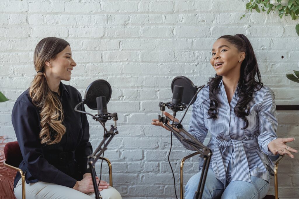two ladies talking on a podcast